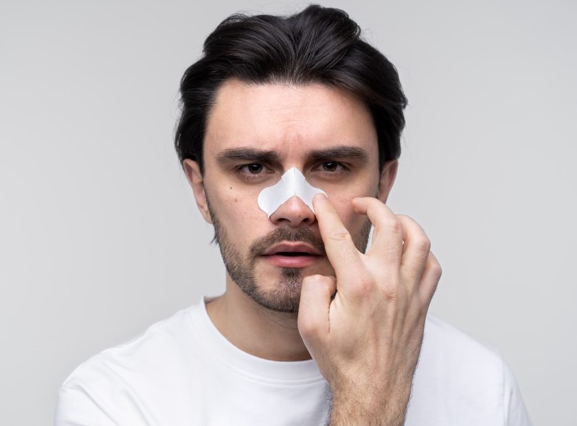 portrait young man applying nose patch min